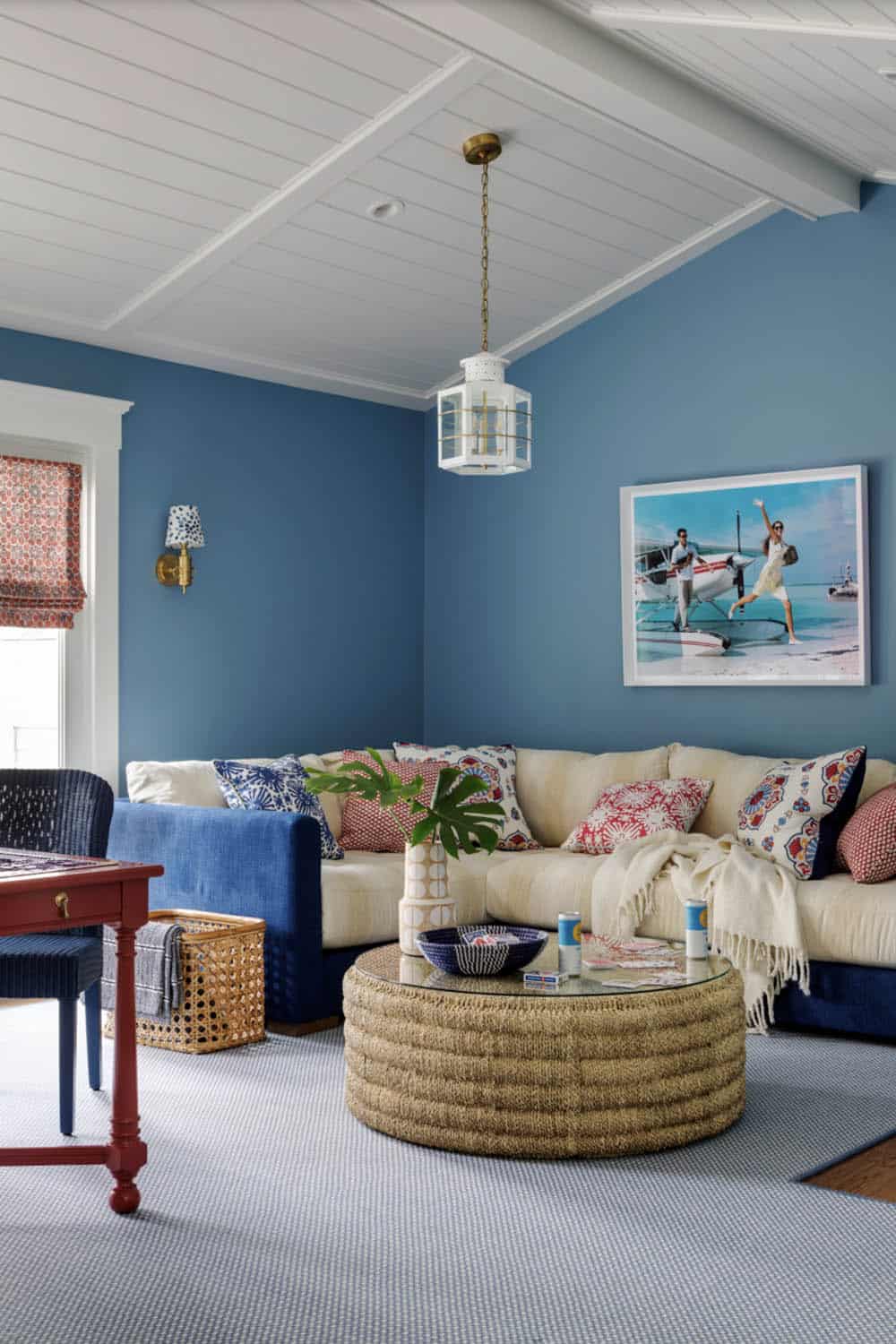 Blue den with cream sectional and framed seaplane photograph