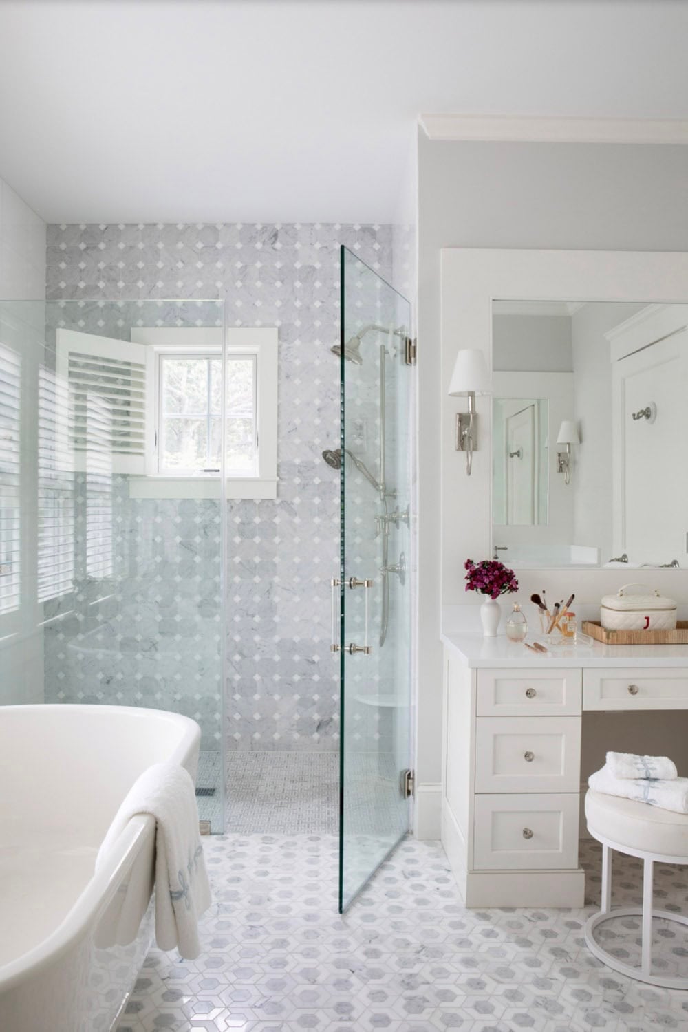 Primary bathroom with freestanding tub and glass shower enclosure