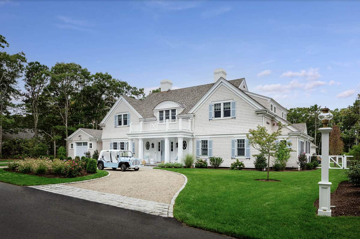 Front exterior of shingle style home at dusk with golf cart