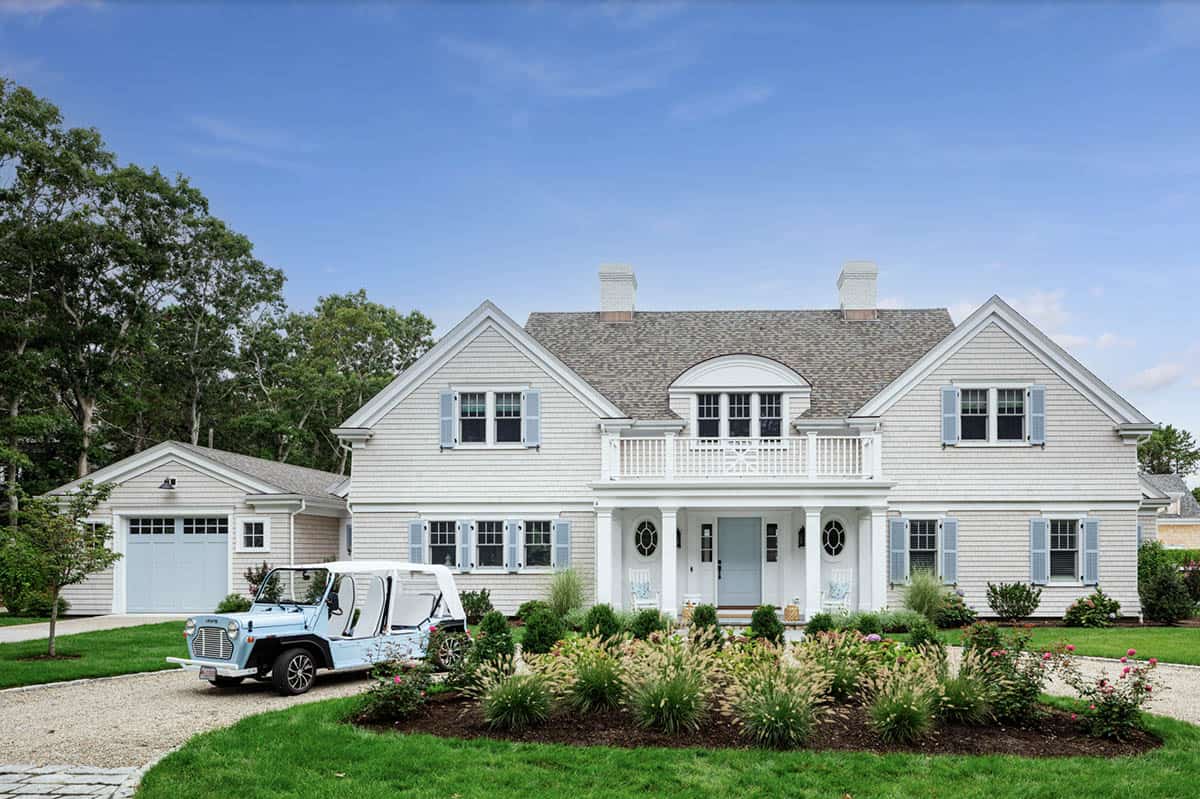 Daytime view of shingle home facade with circular driveway