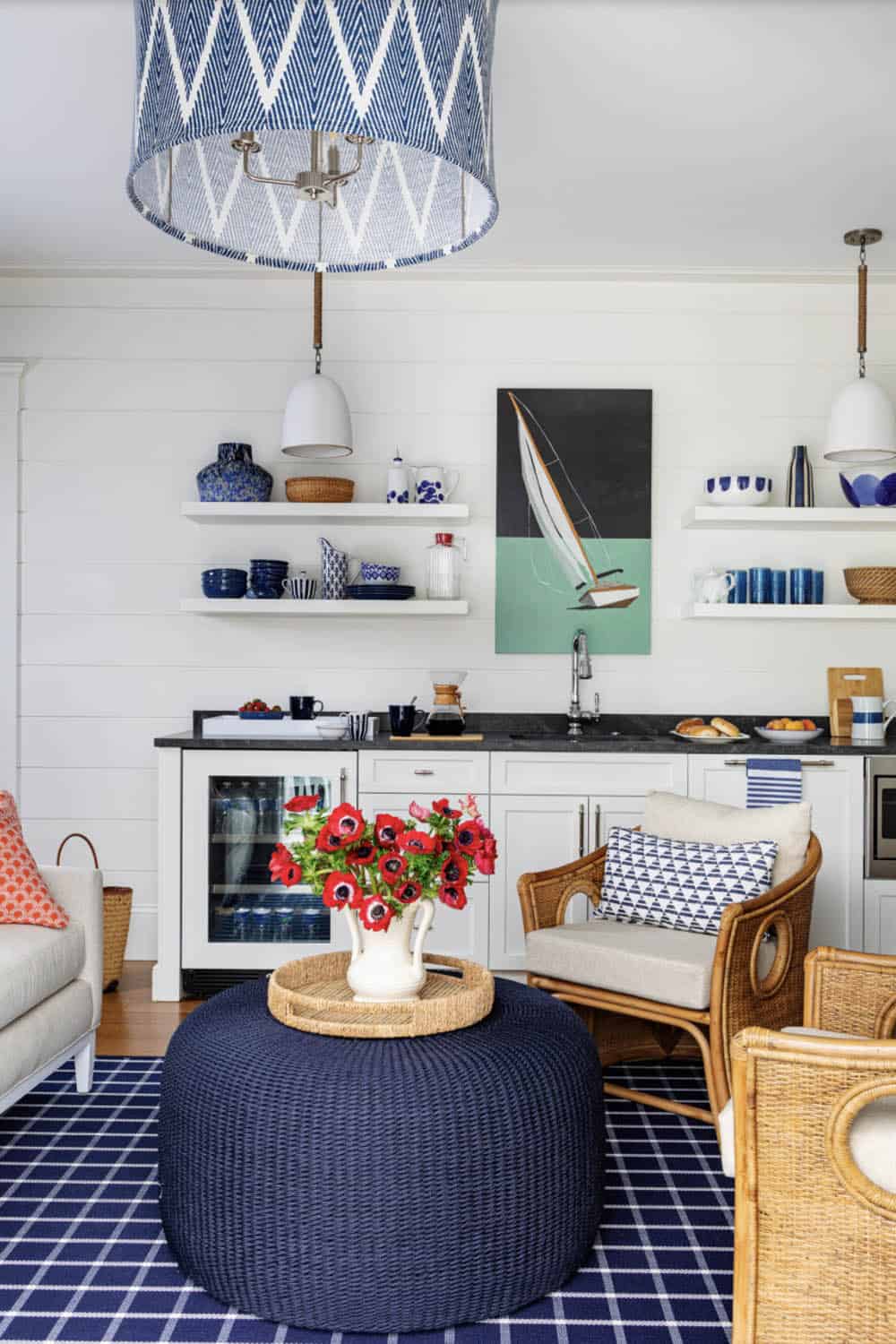 Casual lounge nook with rattan chairs and sailboat artwork