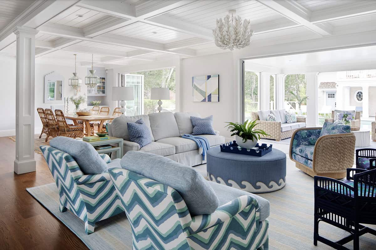 Open living room with chevron chairs and wicker dining table beyond