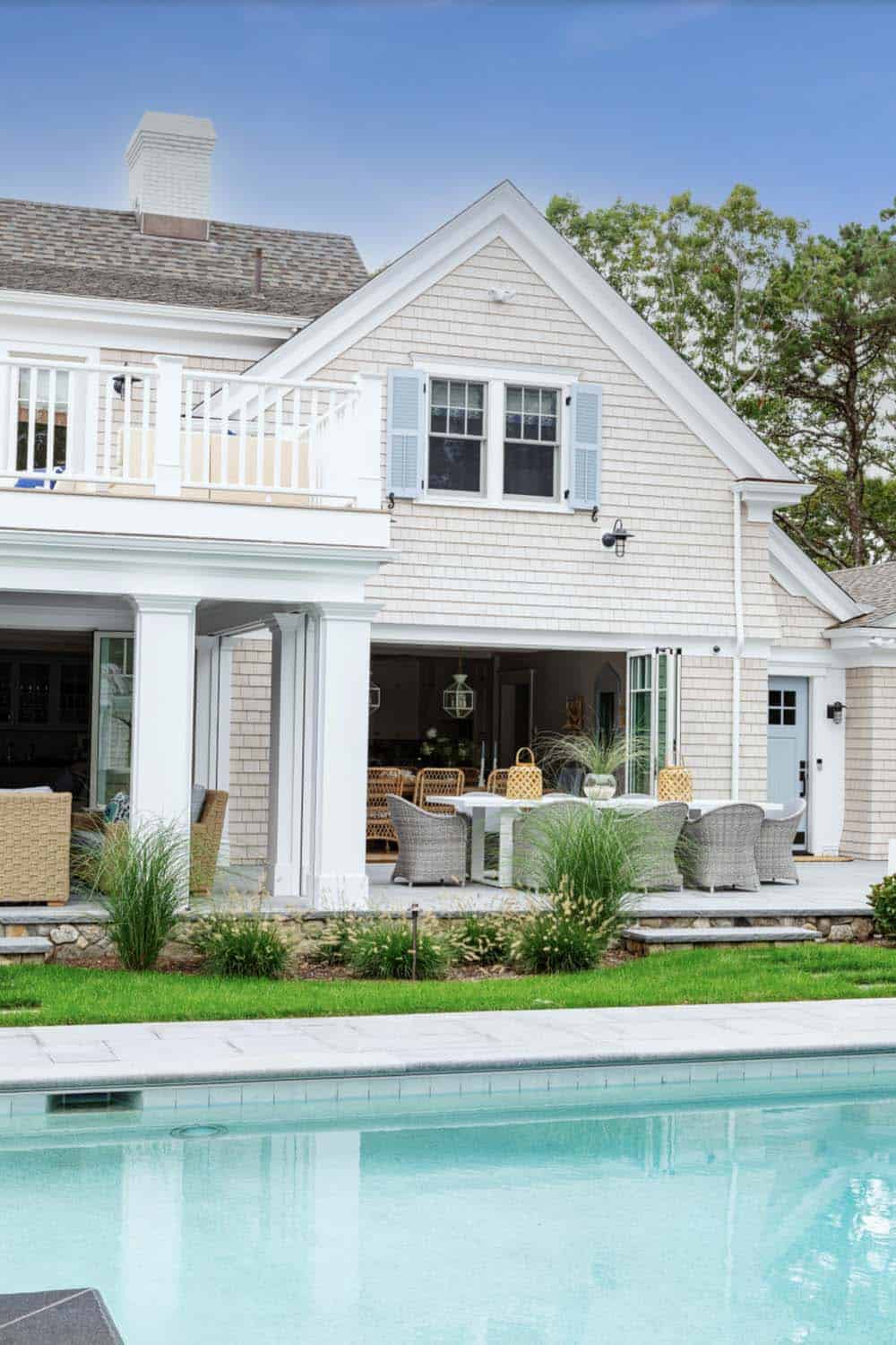 Side view of shingled home with covered patio dining area