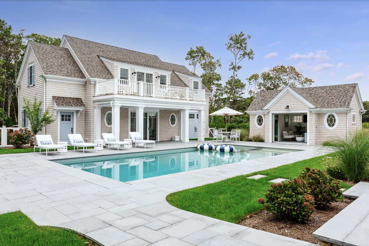 Wide pool view with lounge chairs and detached pool house