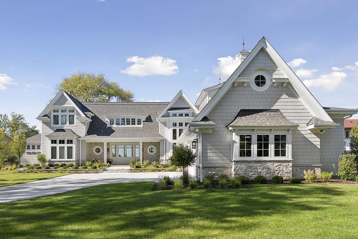 Side exterior view showing shingle siding, stone base, and cupola detail