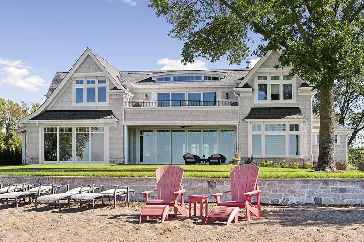 Rear exterior view from beach with red Adirondack chairs