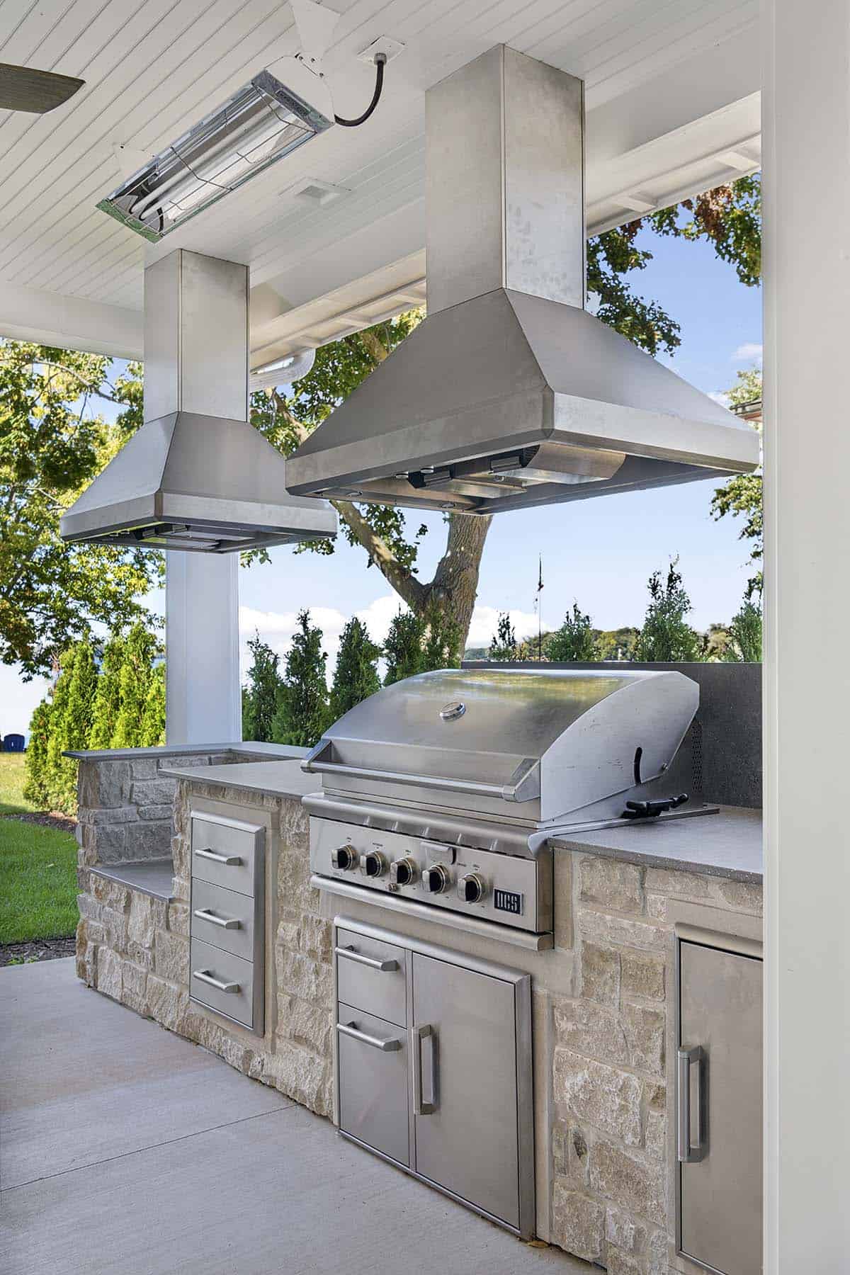Outdoor kitchen with stainless steel grill and stone counter