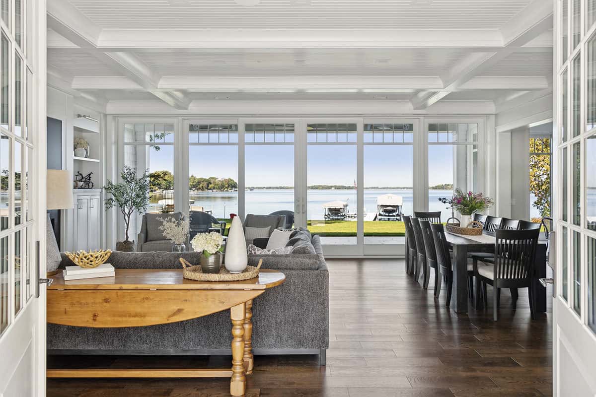 Living and dining space with lake view through glass doors