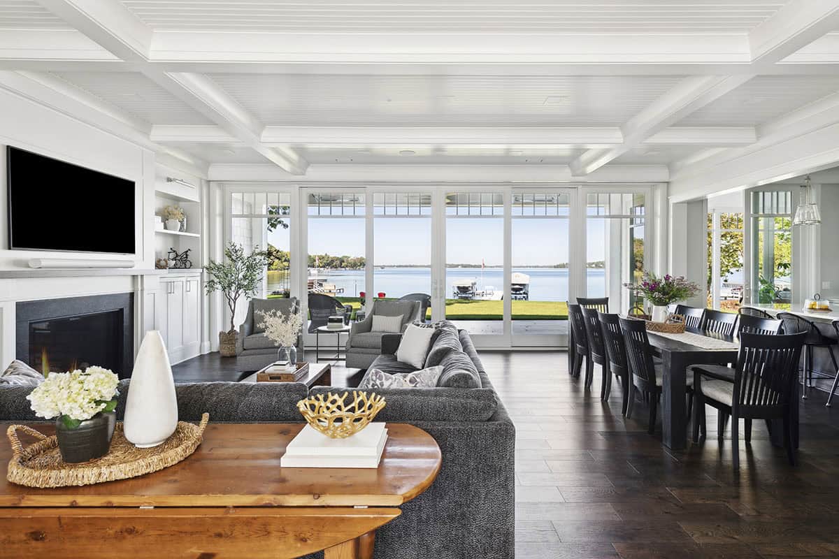 Great room with fireplace, TV, and panoramic lake views