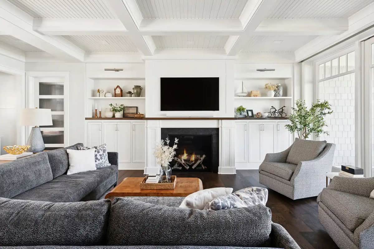 Wide view of living room with sectional sofas and fireplace