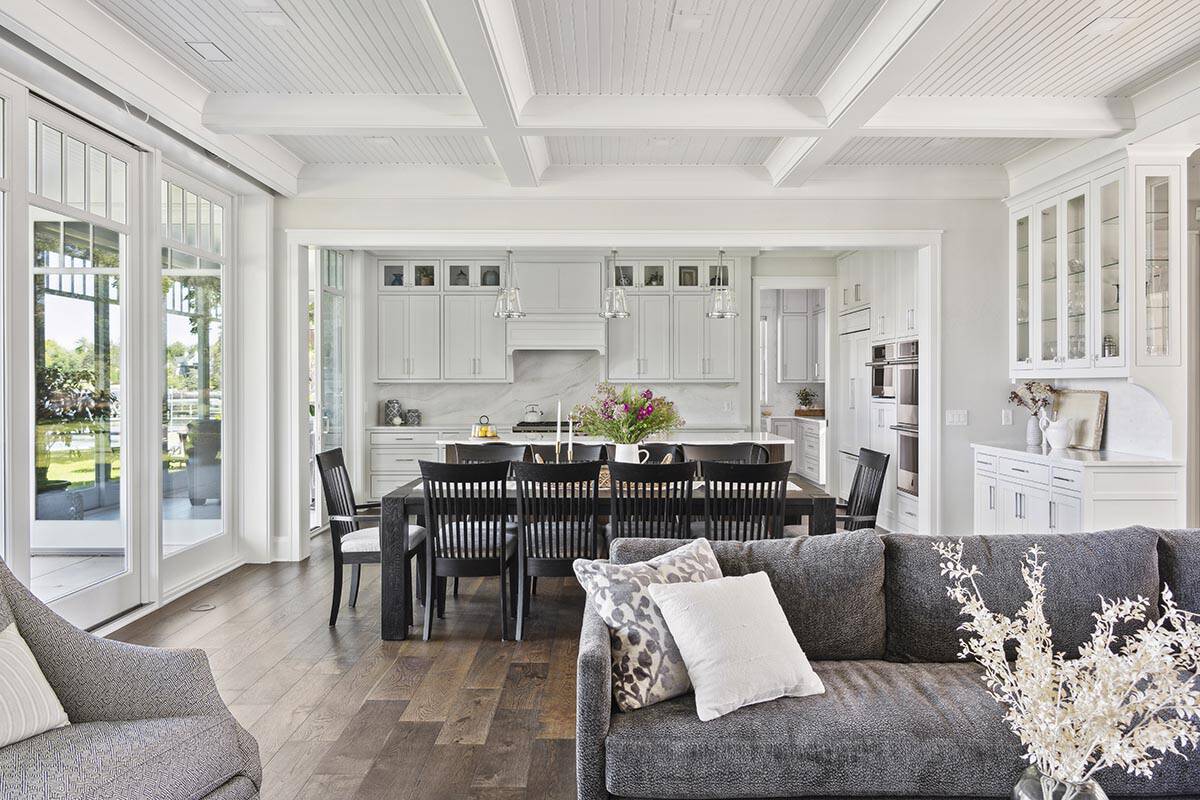 Open kitchen and dining area with white cabinetry and dark wood table