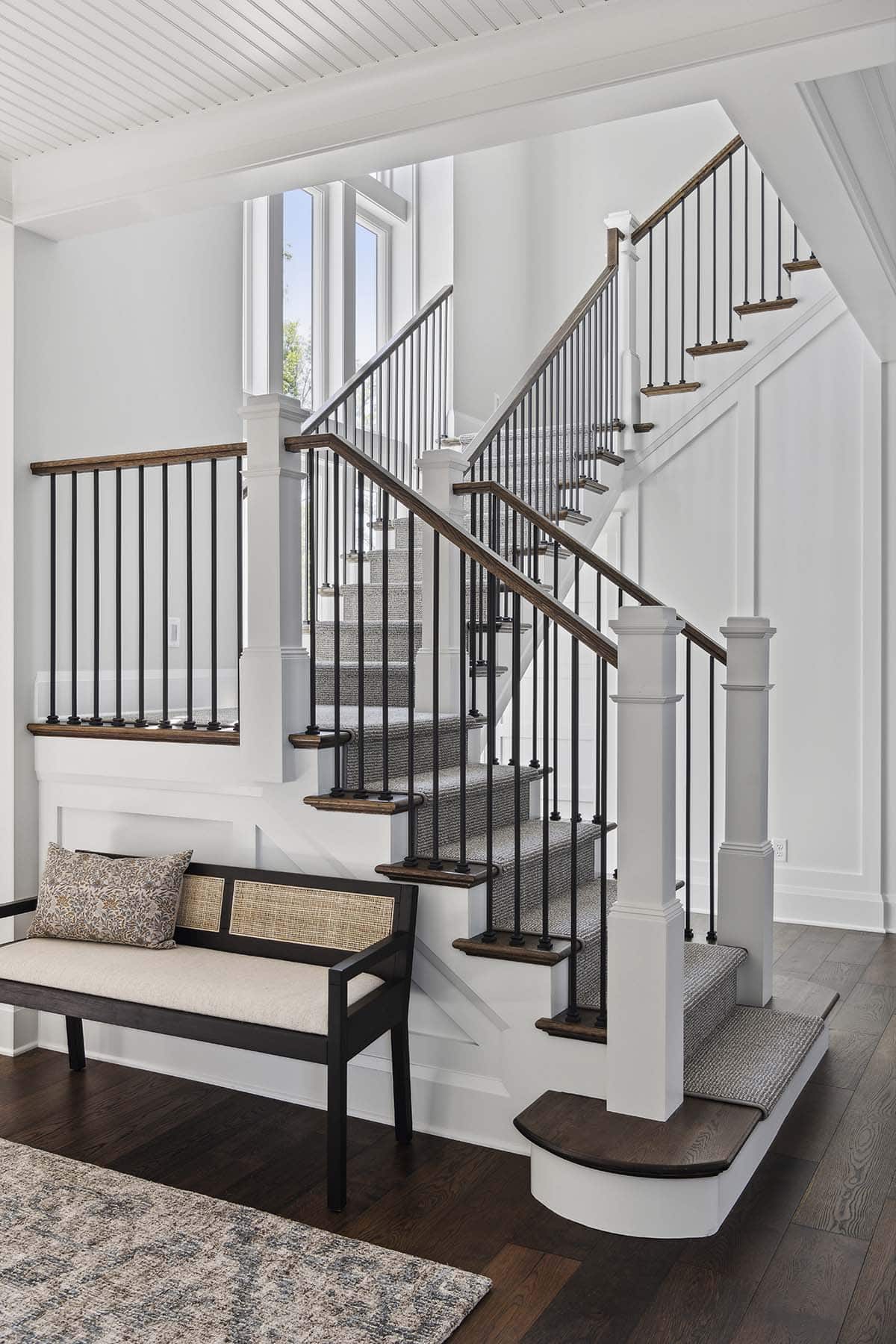 Open staircase with iron balusters and wood handrail