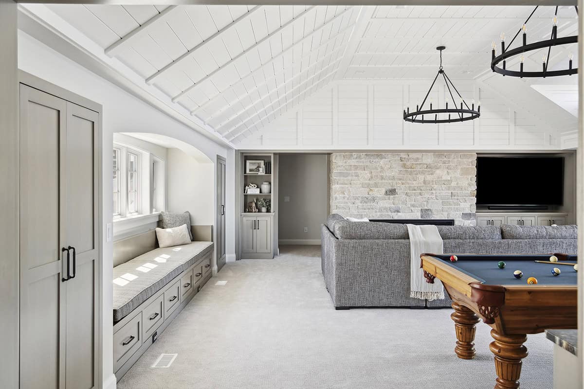 Vaulted family room with pool table, sectional, and window seat