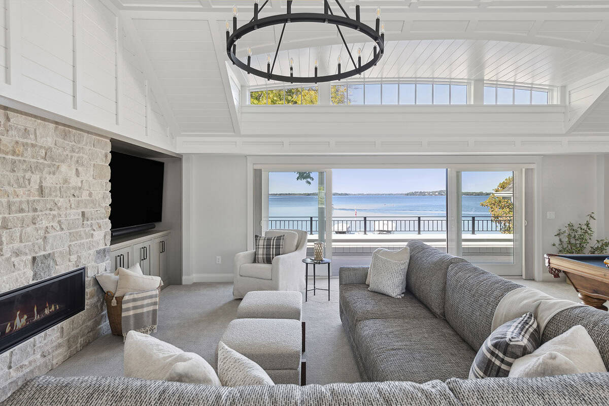 Family room sofa facing lake through sliding glass doors