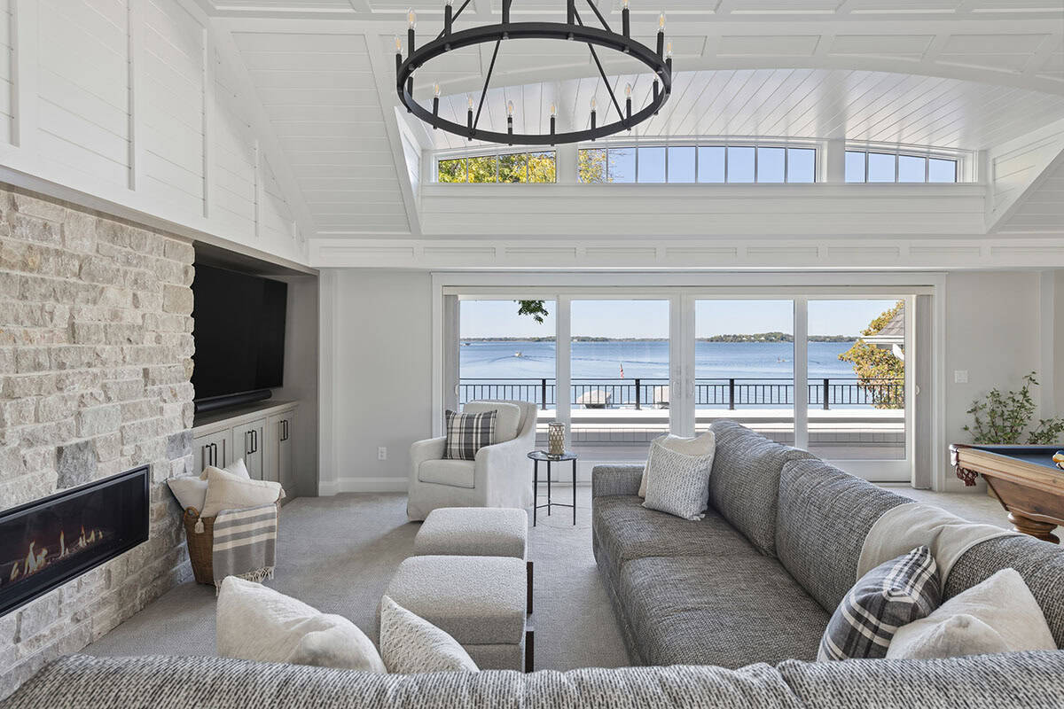 Wide view of family room with fireplace and lake views