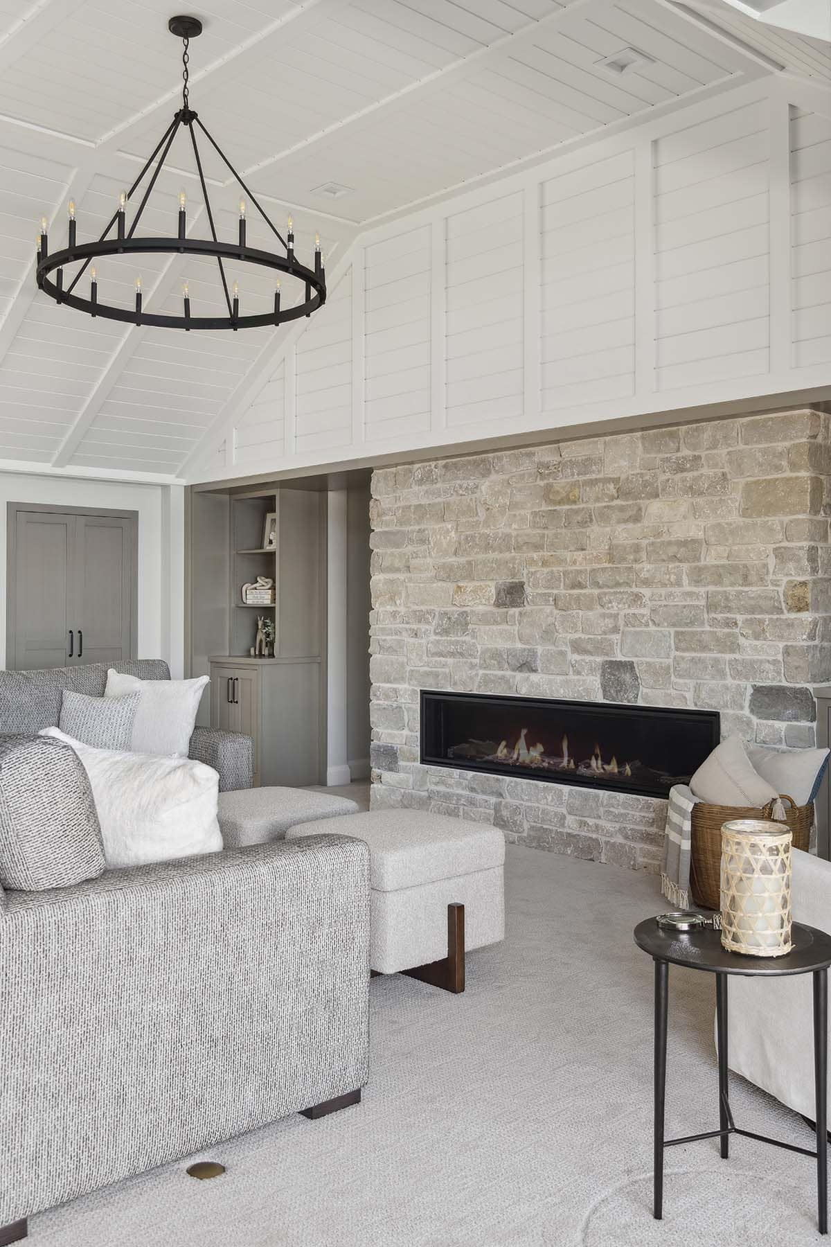 Close-up of stone fireplace and seating in family room