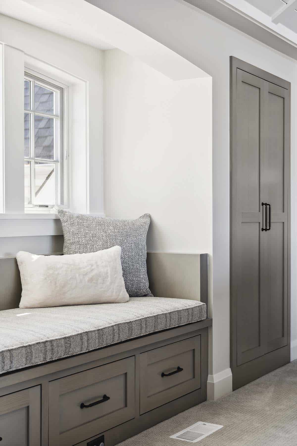 Close-up of window seat cushions and closet door