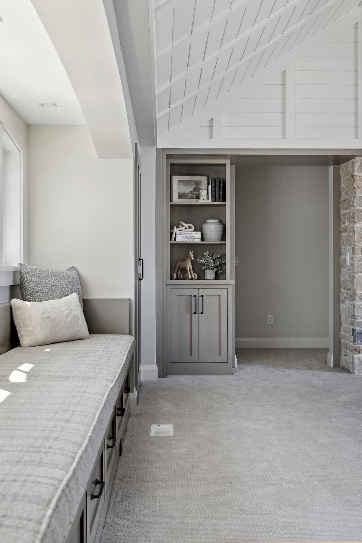 Window seat with view into adjoining room and shelving