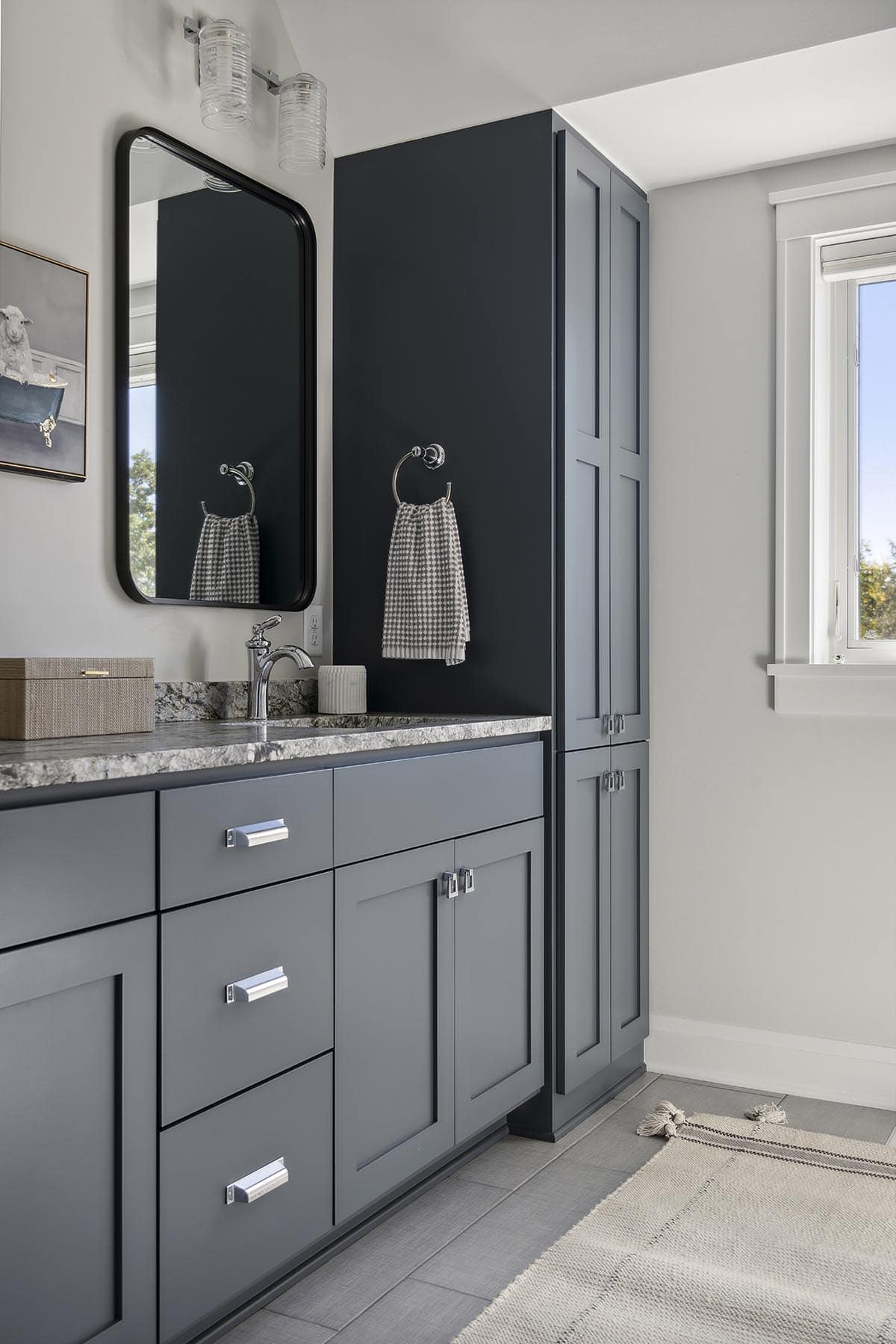 Navy vanity with black mirror and towel ring detail