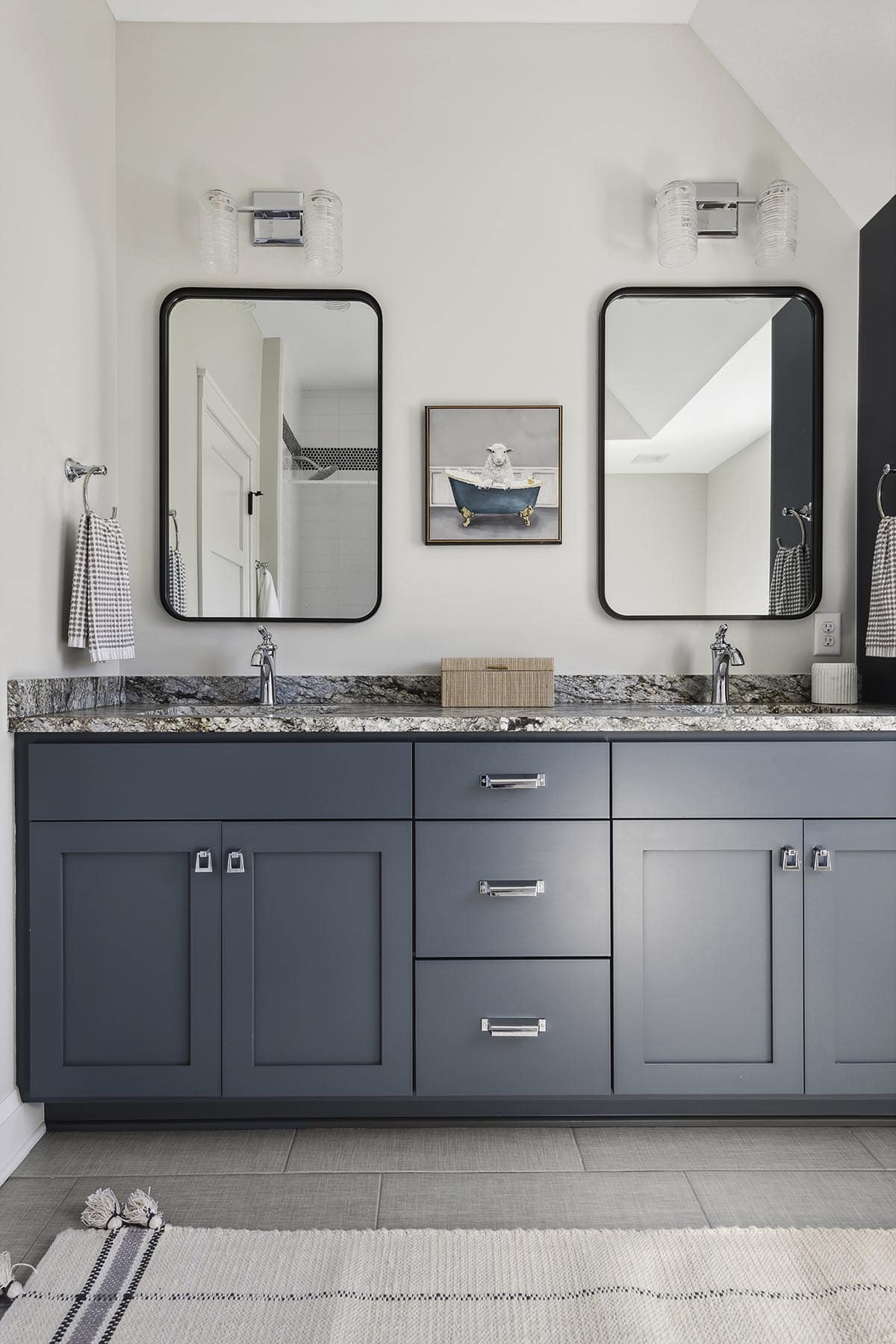 His-and-hers navy vanity with granite counter and mirrors