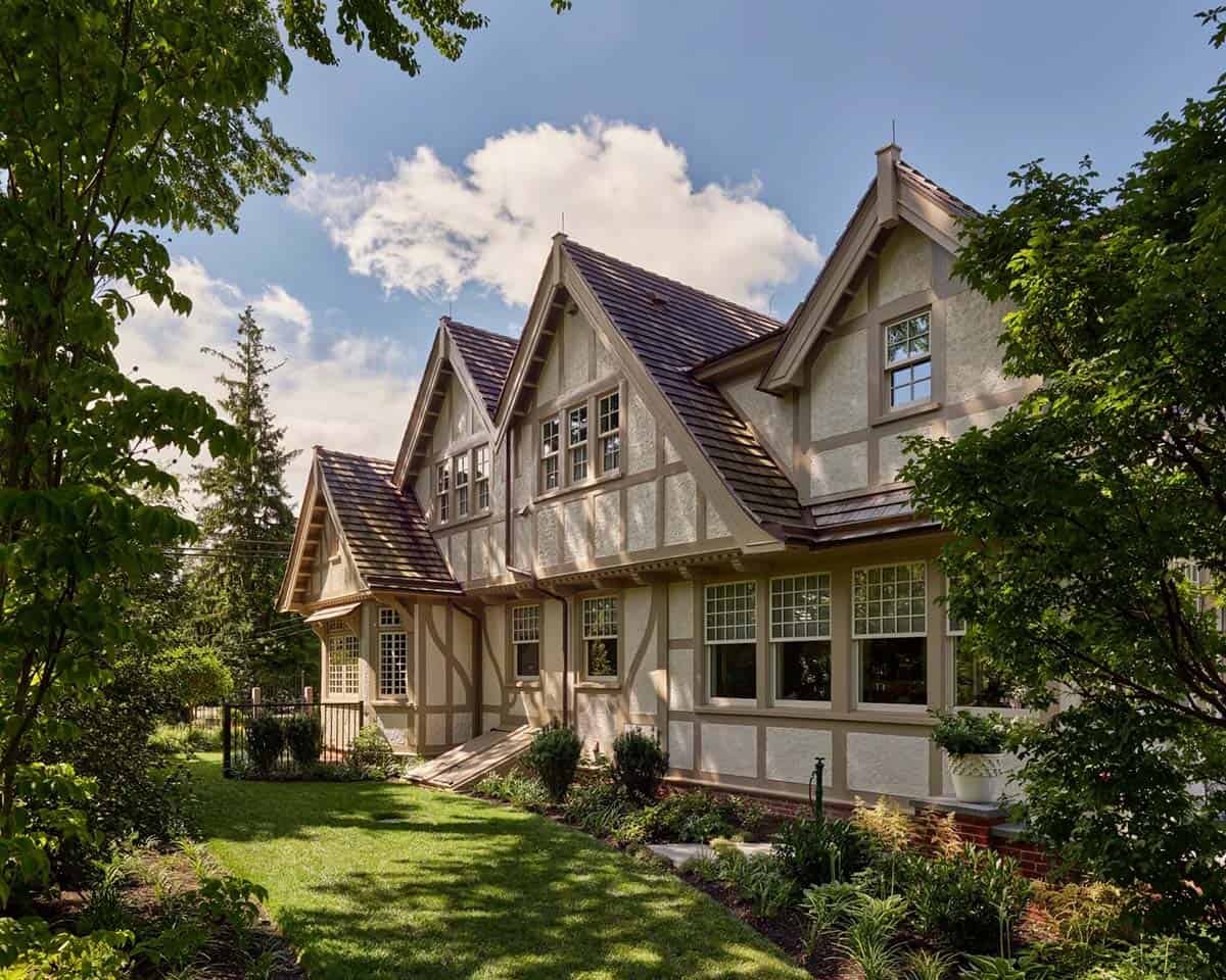 Side view of the Tudor house showing multiple peaked gables and stucco-and-timber facade