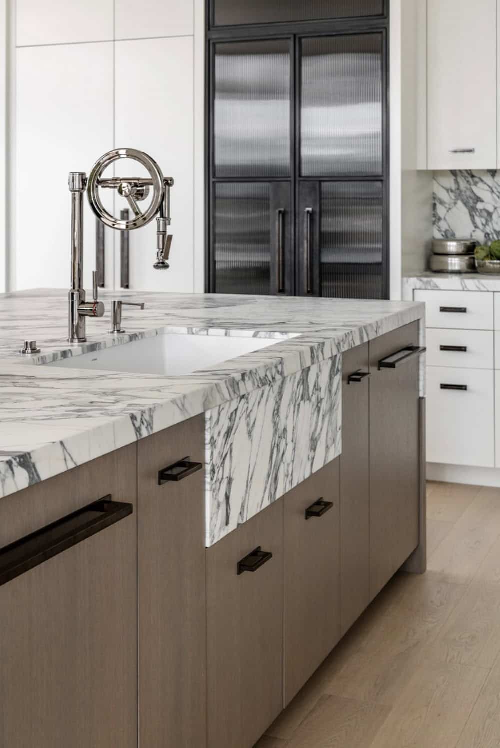 Kitchen island with marble farmhouse sink and polished nickel faucet