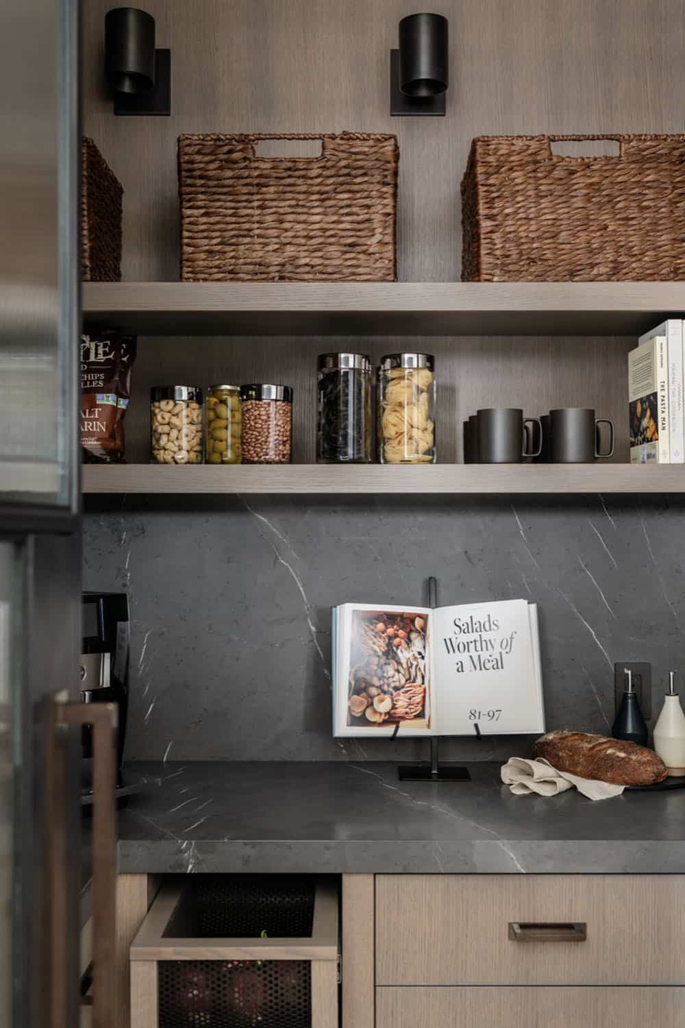 Pantry shelving with baskets, pantry staples, and cookbook display