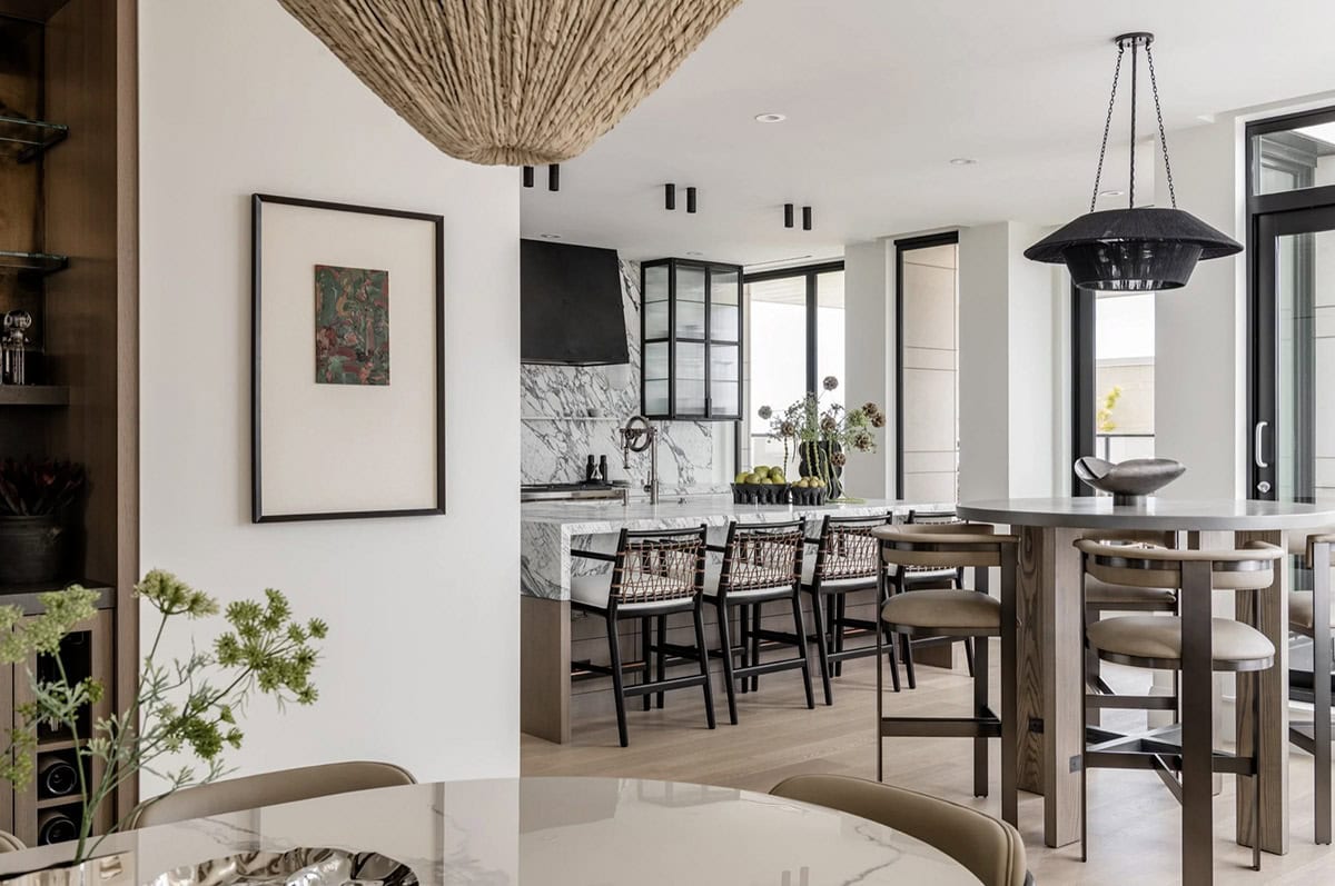 Dining area with woven pendant light overlooking kitchen island
