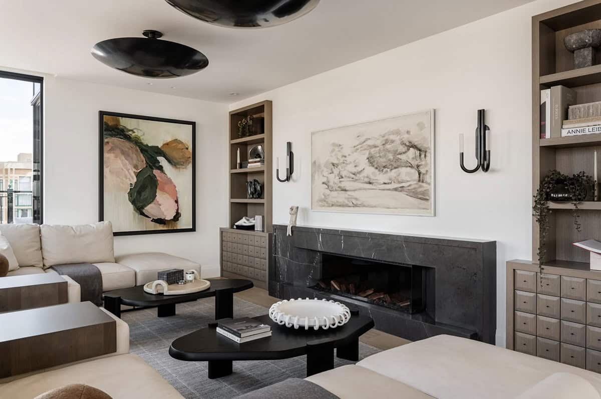 Living room with black marble fireplace and abstract art