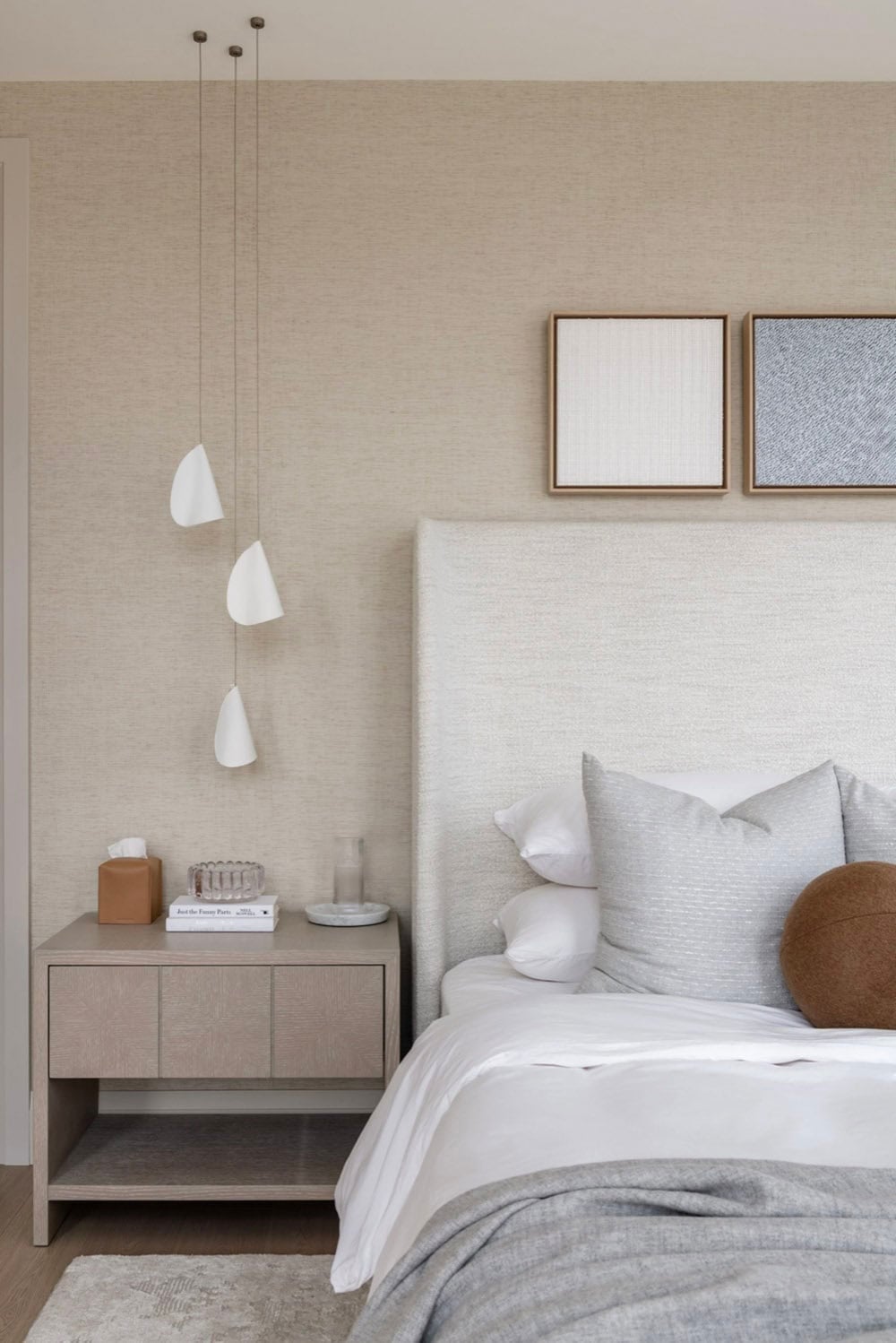 Bedroom nightstand with cone pendant lights and upholstered headboard