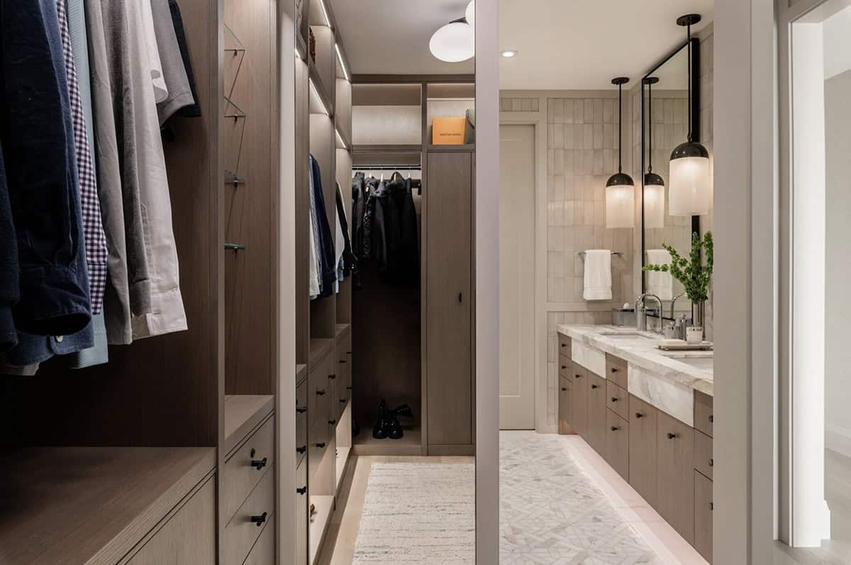View from closet into bathroom with marble double vanity