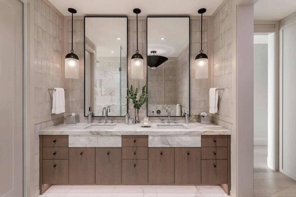 Bathroom double vanity with marble countertop and pendant lighting
