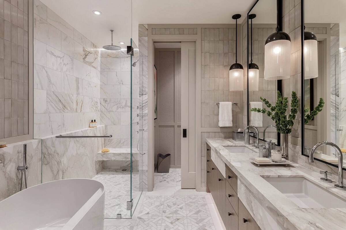 Bathroom with marble shower, freestanding tub, and pendant lighting