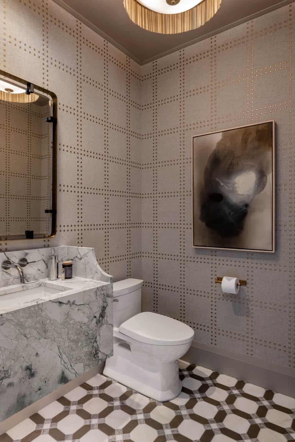 Powder room with patterned wallpaper and marble vanity