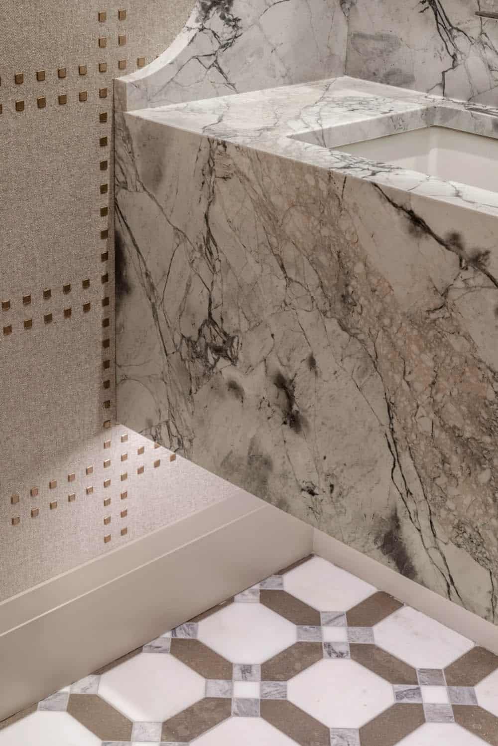 Marble vanity corner detail with geometric tile flooring