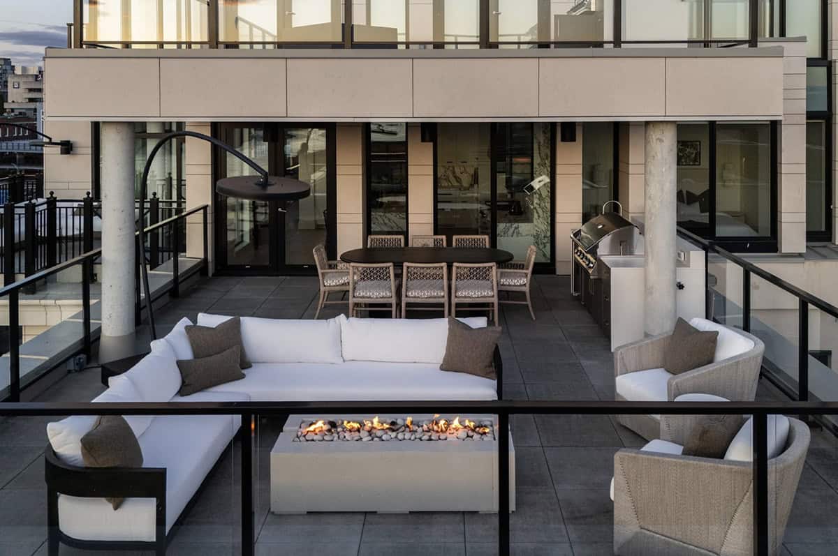 Rooftop terrace with fire pit, lounge seating, and outdoor kitchen