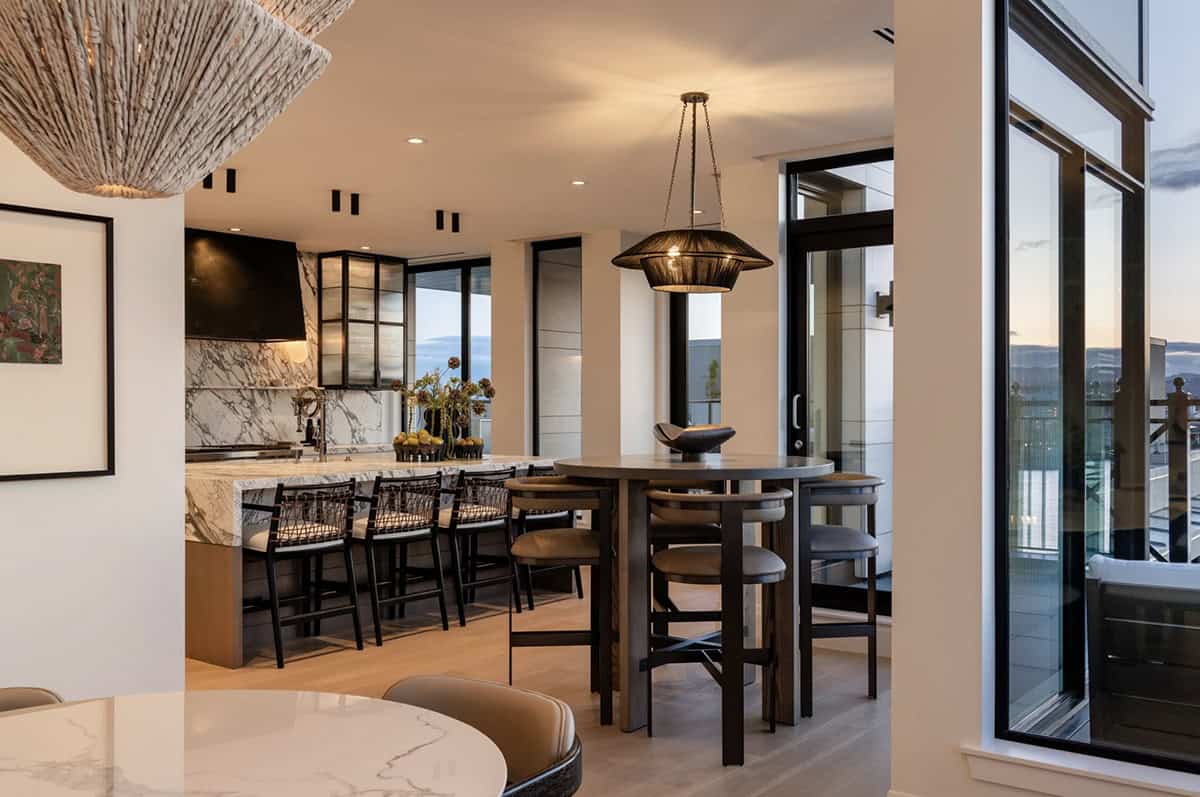 Dining and kitchen area with terrace views at dusk