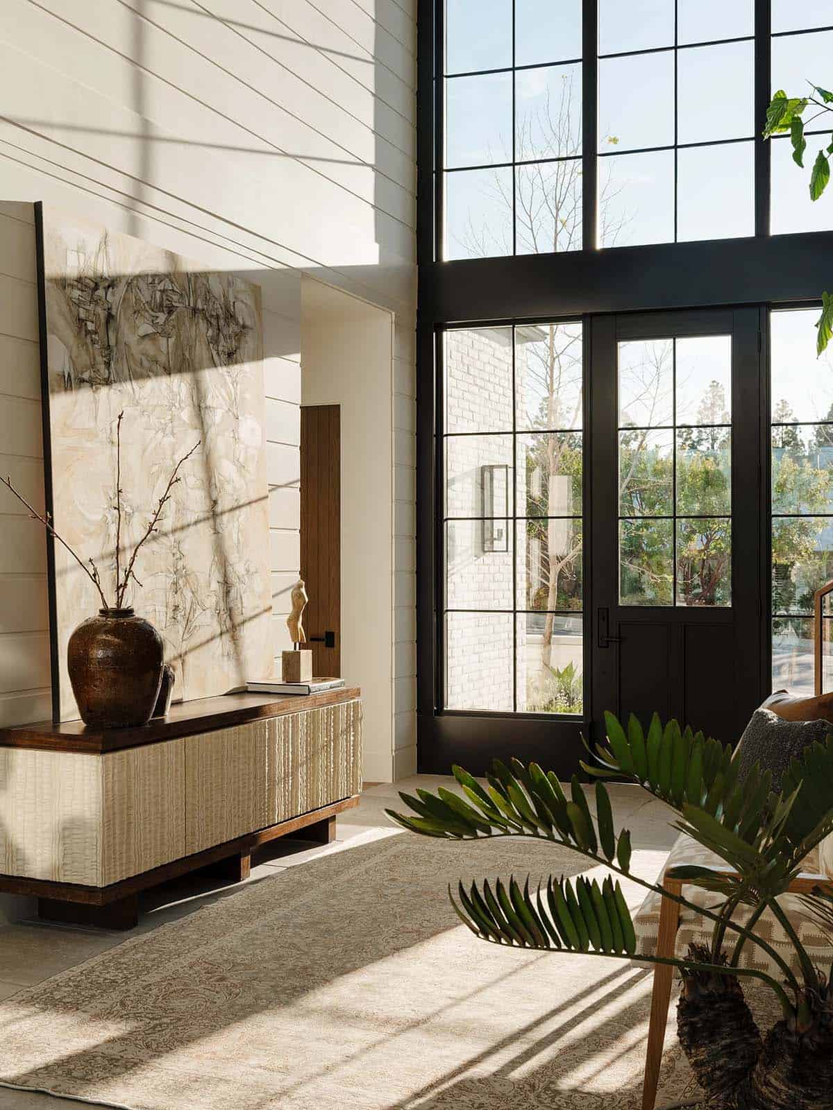 Bright foyer with soaring ceiling and console table