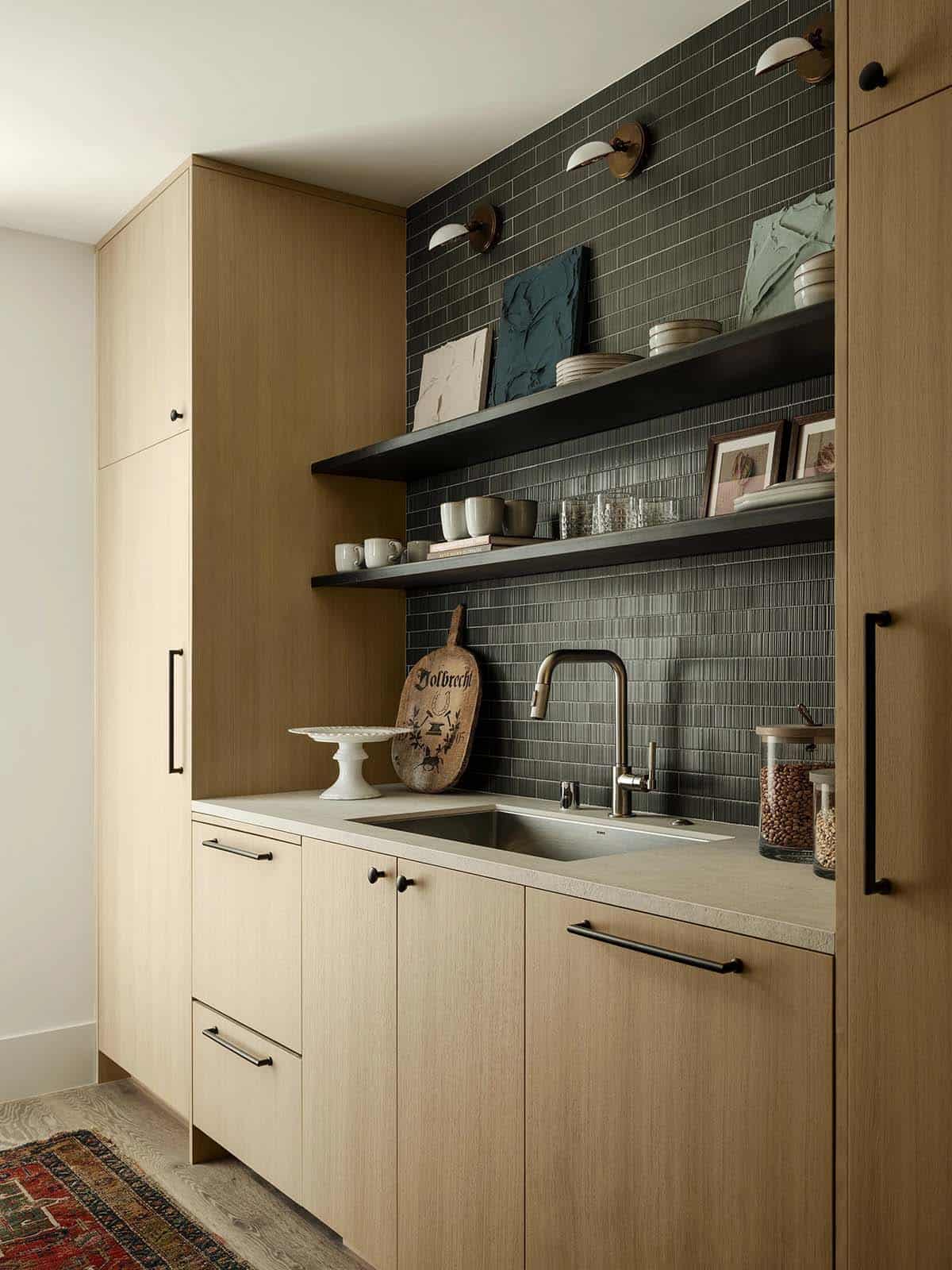 Organized butler's pantry with custom cabinetry and stone countertops