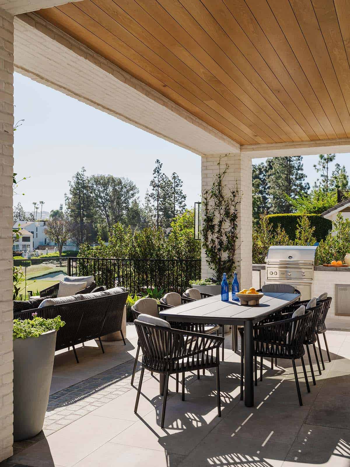 Covered outdoor patio with lounge seating and golf course views