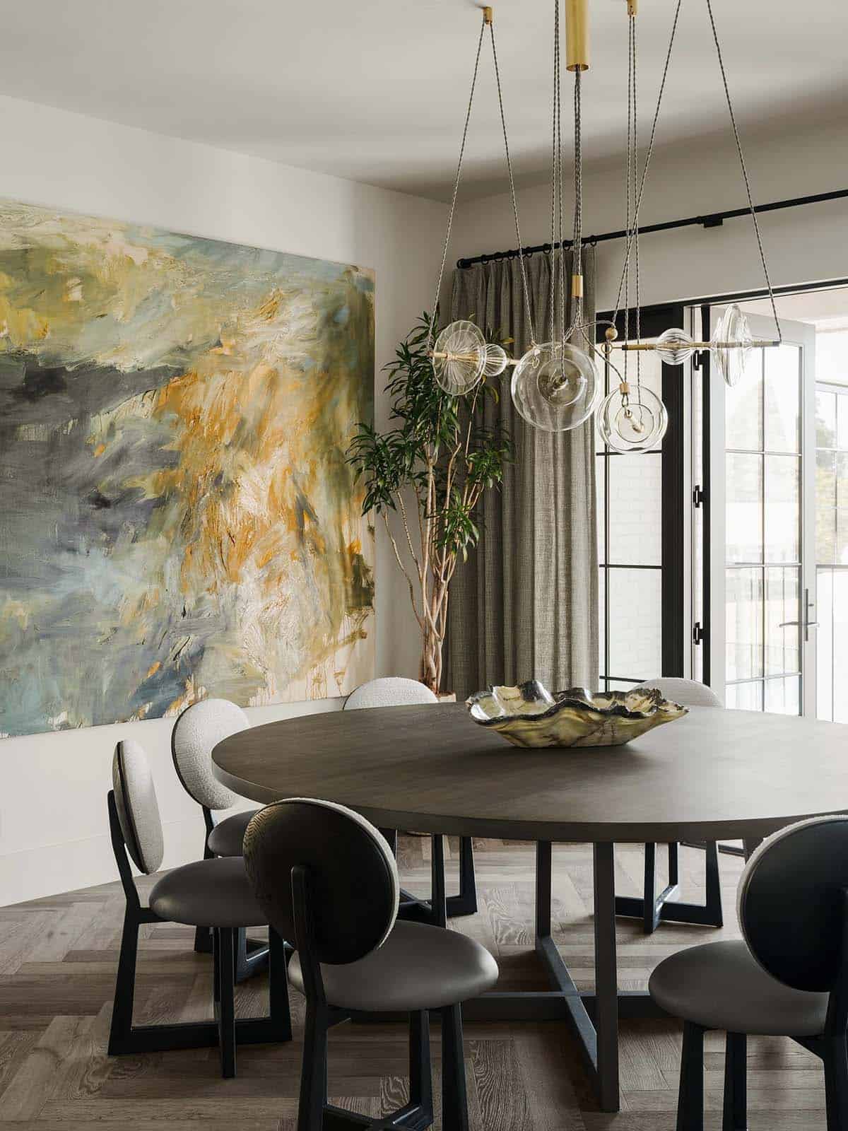 Contemporary dining room with statement lighting and artwork