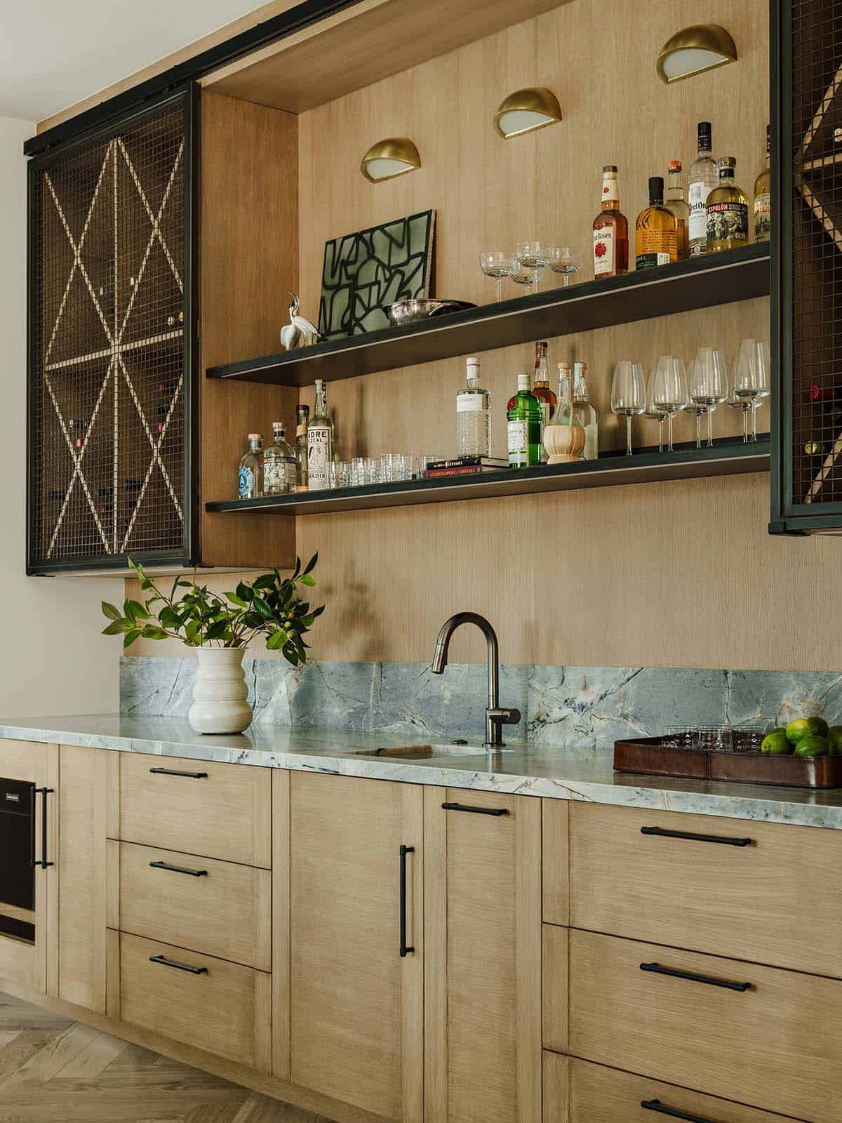 Sleek wet bar with backlit shelving and stone countertop