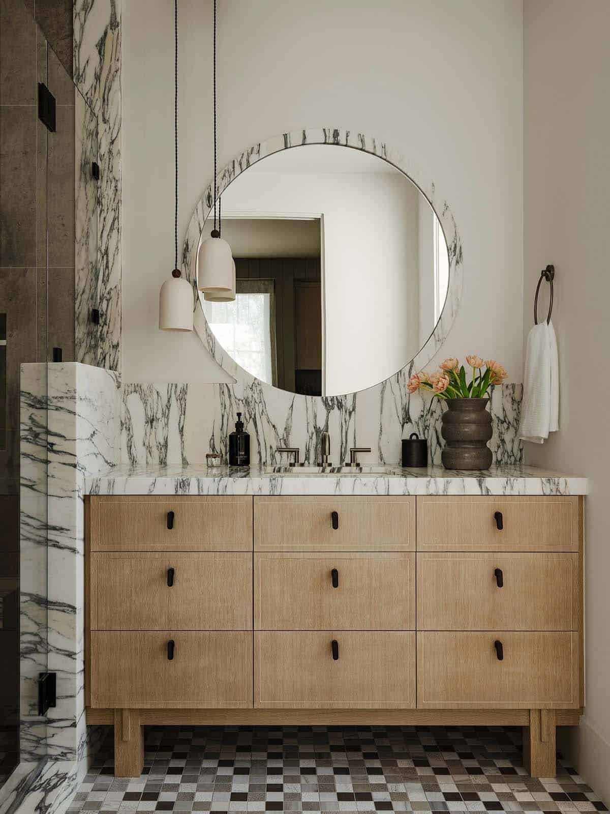 Guest bathroom vanity with a round mirror