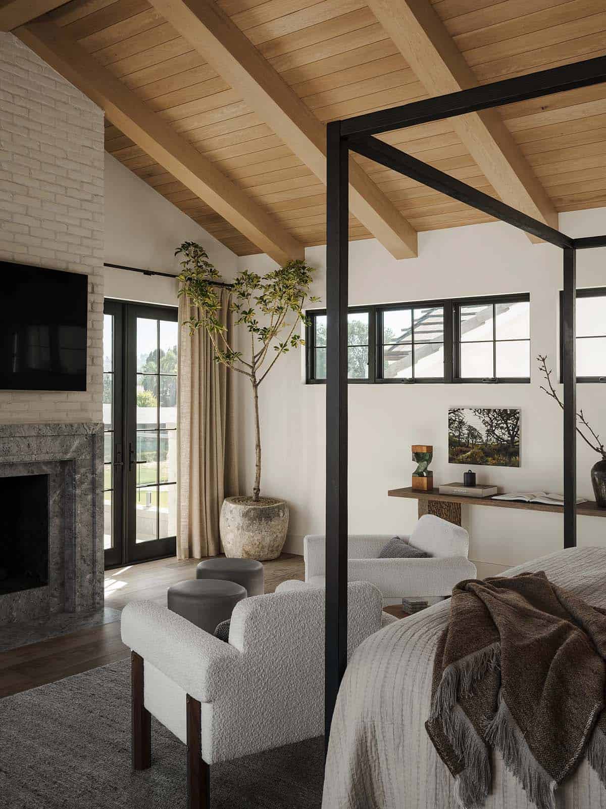 Primary bedroom featuring modern furnishings and a fireplace