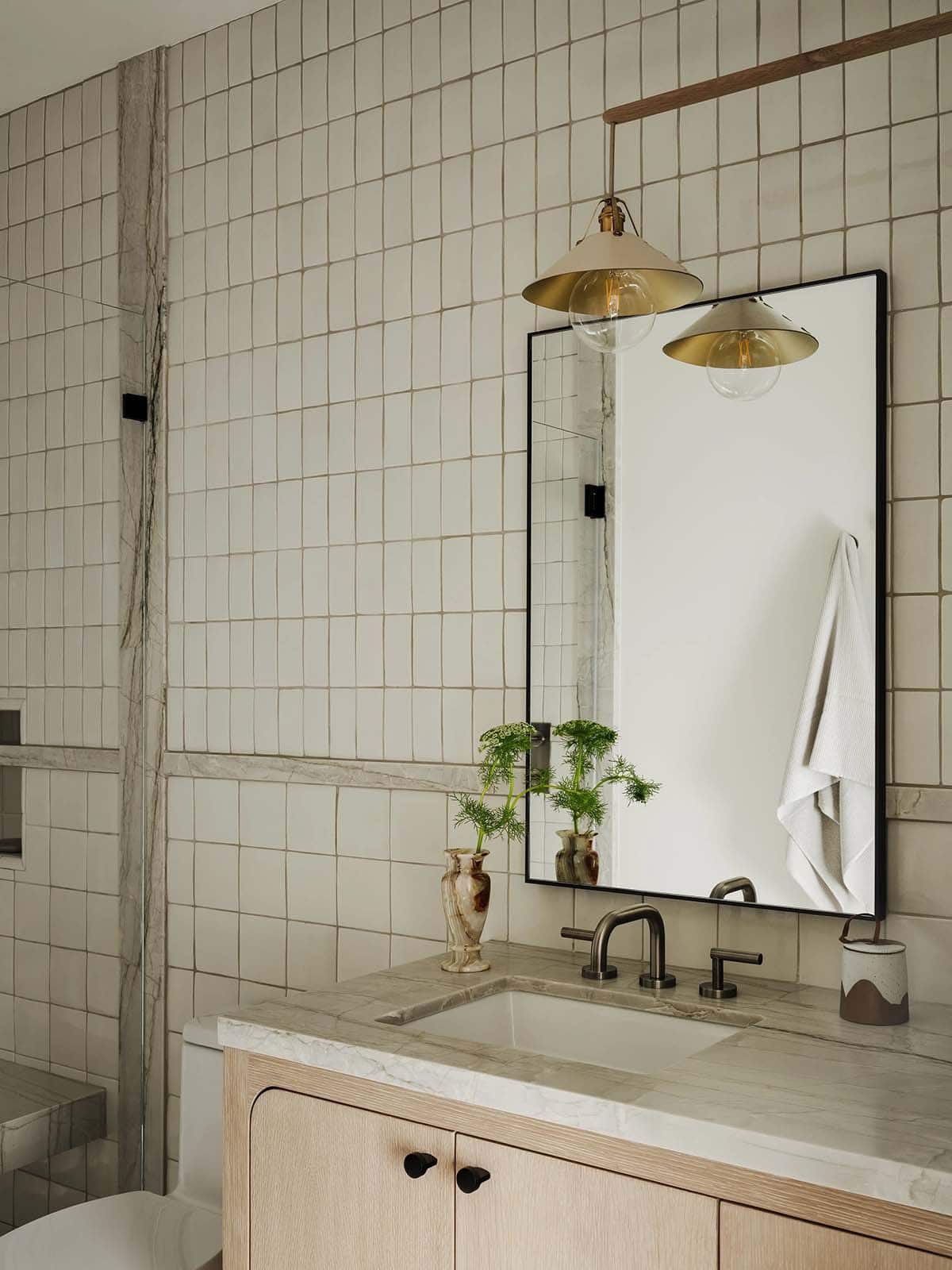 Bathroom with a vanity tile wall and shower