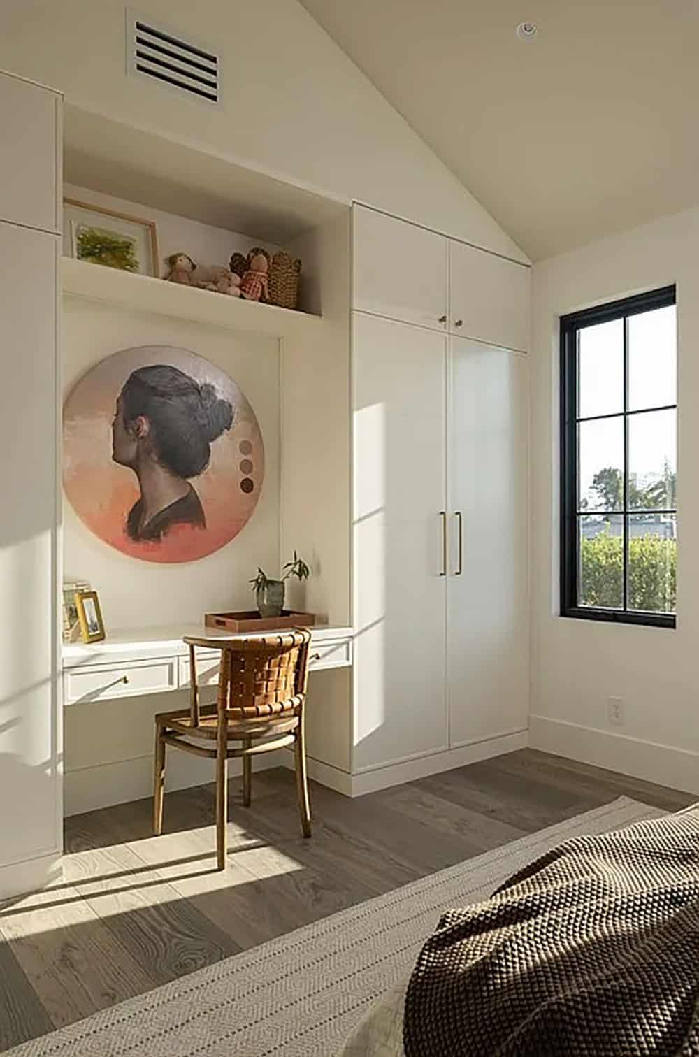 contemporary guest bedroom with built-in closet storage and desk with a chair
