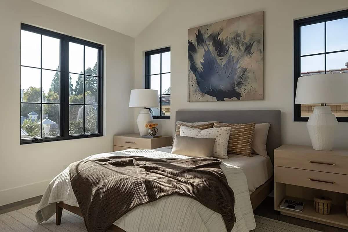 contemporary guest bedroom with a bed and artwork on the wall