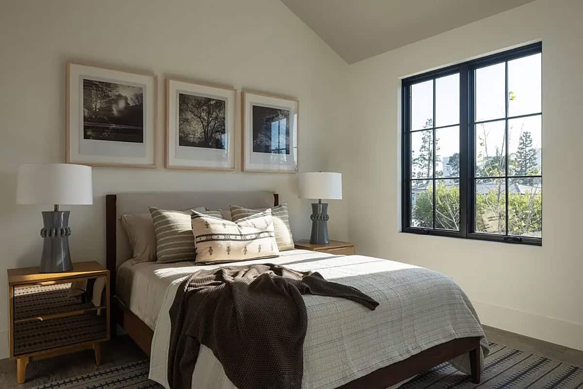 contemporary guest bedroom with a bed and a trio of artwork on the wall