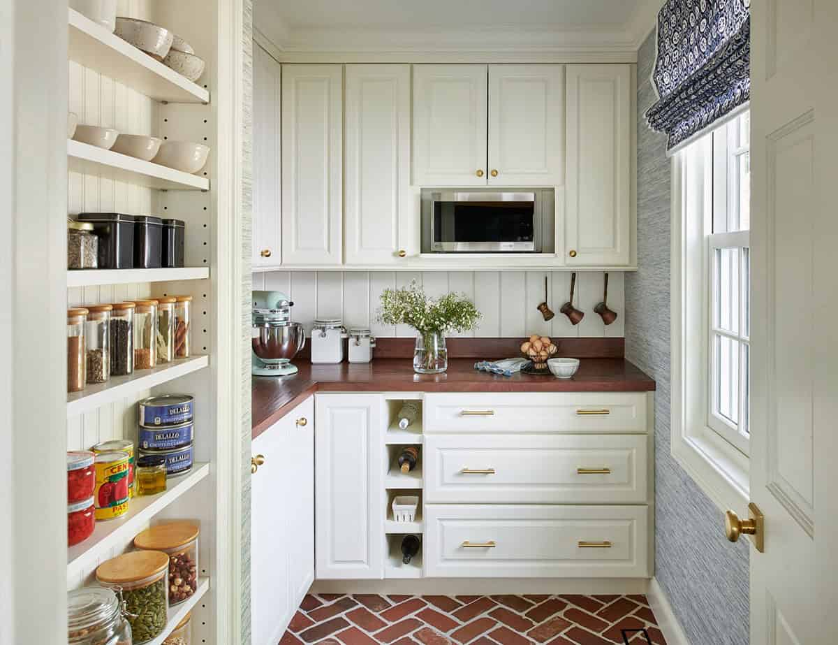 Butler's pantry with open shelving and brick herringbone floor