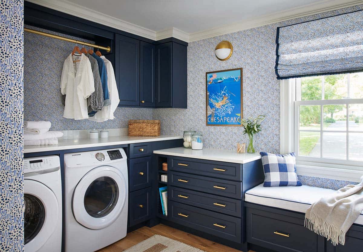 Navy laundry room with floral wallpaper and window seat
